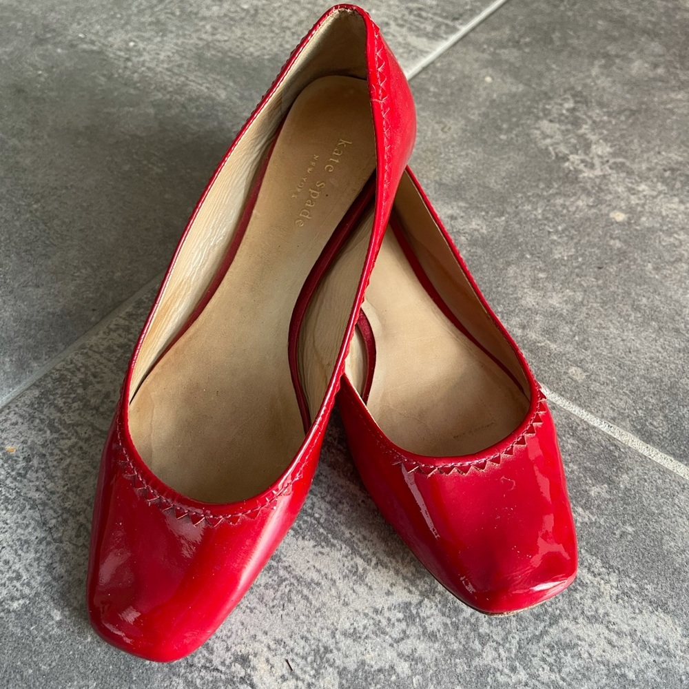 Red Kate Spade slip on shoes.